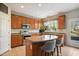Cozy kitchen offering an island with seating, stainless steel appliances, and backyard view at 7604 Derek Dr, Raleigh, NC 27613
