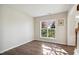 Bright room with hardwood flooring and a large window at 7604 Derek Dr, Raleigh, NC 27613