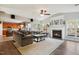 Spacious living room featuring a fireplace, plush seating, and large windows at 7604 Derek Dr, Raleigh, NC 27613