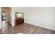Inviting living room features hardwood floors, large window, and open space at 7604 Derek Dr, Raleigh, NC 27613