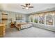 Serene main bedroom with a tray ceiling, natural light, and neutral carpeting at 7604 Derek Dr, Raleigh, NC 27613