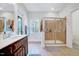 Bright bathroom featuring a modern sink, glass-enclosed shower, and natural light at 7687 Mattie Rd, Rocky Mount, NC 27803