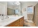Bathroom featuring double sinks, framed mirrors, and neutral-toned walls and tiled floor at 7687 Mattie Rd, Rocky Mount, NC 27803