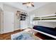 Bright bedroom featuring a bunk bed, ceiling fan, dresser, and decorative shelves filled with figurines at 7687 Mattie Rd, Rocky Mount, NC 27803