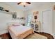 Cozy bedroom with floral bedding, a decorative cabinet, ceiling fan, and view of the outside at 7687 Mattie Rd, Rocky Mount, NC 27803
