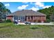 Brick home with screened-in porch, patio, and large backyard at 7687 Mattie Rd, Rocky Mount, NC 27803