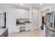 Spacious kitchen featuring stainless steel appliances, white cabinets, and a tile floor at 7687 Mattie Rd, Rocky Mount, NC 27803
