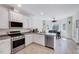 Bright kitchen featuring stainless steel appliances, white cabinetry, and tile floors at 7687 Mattie Rd, Rocky Mount, NC 27803