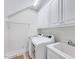Functional laundry room with modern washer, dryer, utility sink, and ample cabinet space at 7687 Mattie Rd, Rocky Mount, NC 27803
