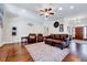Spacious living room with hardwood floors, leather seating, and a ceiling fan at 7687 Mattie Rd, Rocky Mount, NC 27803