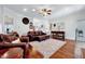Spacious living room featuring hardwood floors, comfortable leather seating, and stylish decor at 7687 Mattie Rd, Rocky Mount, NC 27803