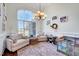 Bright living room with large windows, elegant seating, and stylish decor at 7687 Mattie Rd, Rocky Mount, NC 27803