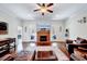 Cozy living room featuring a brick fireplace, mounted TV, and comfortable leather furniture at 7687 Mattie Rd, Rocky Mount, NC 27803