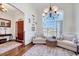 Bright living room with large windows, elegant seating, and stylish decor at 7687 Mattie Rd, Rocky Mount, NC 27803