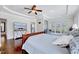 Tranquil main bedroom featuring hardwood floors, modern furniture, and a tray ceiling at 7687 Mattie Rd, Rocky Mount, NC 27803