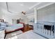 Comfortable main bedroom featuring hardwood floors, modern crib, and a tray ceiling at 7687 Mattie Rd, Rocky Mount, NC 27803
