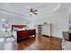 Bright main bedroom featuring hardwood floors, modern furniture, and a ceiling fan at 7687 Mattie Rd, Rocky Mount, NC 27803