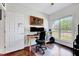 Office with hardwood floors, large window, an executive chair, and a desk with dual monitors at 7687 Mattie Rd, Rocky Mount, NC 27803