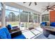 Screened-in porch featuring comfortable seating, ceiling fans, and a view of the backyard at 7687 Mattie Rd, Rocky Mount, NC 27803