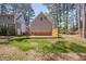 View of home's backyard with grass and tree line at 7917 Blaney Franks Rd, Apex, NC 27539