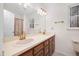 This bathroom features double vanity sinks, modern lighting, and a large vanity mirror at 7917 Blaney Franks Rd, Apex, NC 27539