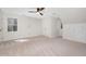 Cozy carpeted bedroom with a ceiling fan and white walls at 7917 Blaney Franks Rd, Apex, NC 27539