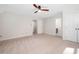 Spacious carpeted bedroom with two entryways and a ceiling fan at 7917 Blaney Franks Rd, Apex, NC 27539