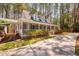 Low-angle view of a Cape Cod home with a wrap-around porch, showcasing its inviting curb appeal at 7917 Blaney Franks Rd, Apex, NC 27539