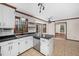 Bright kitchen area with modern appliances, subway tile backsplash, and views into the living room at 7917 Blaney Franks Rd, Apex, NC 27539