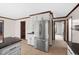 Open concept kitchen with stainless steel refrigerator and view of other rooms at 7917 Blaney Franks Rd, Apex, NC 27539