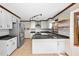 Bright kitchen features white cabinetry, subway tile, stainless steel appliances, and dark granite countertops at 7917 Blaney Franks Rd, Apex, NC 27539