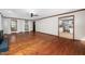 Open-concept living room with hardwood floors and natural light flowing into the kitchen at 7917 Blaney Franks Rd, Apex, NC 27539