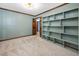 Bright living room with carpet, blue-green walls, and a built-in bookshelf at 7917 Blaney Franks Rd, Apex, NC 27539