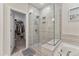 Modern bathroom featuring glass shower, soaker tub and access to closet at 803 Toulouse Ct, Cary, NC 27519