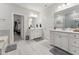 Luxury bathroom with dual vanities and open entry to a walk-in closet at 803 Toulouse Ct, Cary, NC 27519