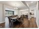 Open dining area with elegant chandelier and flows into the living room and kitchen at 803 Toulouse Ct, Cary, NC 27519