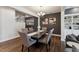 Open dining room with gray walls and a modern table set, adjacent to living area at 803 Toulouse Ct, Cary, NC 27519