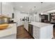 Modern kitchen featuring a large island, stainless steel appliances, and white cabinetry at 803 Toulouse Ct, Cary, NC 27519