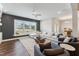 Spacious living room featuring a sectional sofa, modern ceiling fan, and sunlit windows at 803 Toulouse Ct, Cary, NC 27519