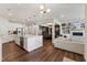 Spacious open-concept living area with a kitchen island, dining space, and comfortable seating at 803 Toulouse Ct, Cary, NC 27519