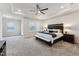 Spacious primary bedroom with tray ceiling, ambient lighting, and plush carpet at 803 Toulouse Ct, Cary, NC 27519