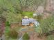 Overhead view showcases a charming home nestled among mature trees at 8504 Old Nc 86, Chapel Hill, NC 27516