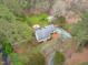 Aerial view of a beautiful home with a fire pit and lush greenery at 8504 Old Nc 86, Chapel Hill, NC 27516
