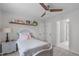 Cozy bedroom features a ceiling fan, neutral walls, and a decorative shelf at 8504 Old Nc 86, Chapel Hill, NC 27516