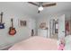 Comfortable bedroom featuring a ceiling fan, neutral walls, and decorative guitars at 8504 Old Nc 86, Chapel Hill, NC 27516