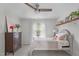 Bright bedroom with wood dresser, hardwood floors, ceiling fan, and comfortable bed at 8504 Old Nc 86, Chapel Hill, NC 27516