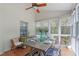Bright dining area with a ceiling fan, windows and a rustic dining table at 8504 Old Nc 86, Chapel Hill, NC 27516