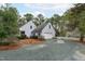 Exterior view of home with gravel driveway, garage, and partial fence at 8504 Old Nc 86, Chapel Hill, NC 27516