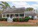 Classic home with a cozy front porch and well-maintained landscaping at 8504 Old Nc 86, Chapel Hill, NC 27516