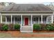Charming front porch with classic columns and a bright red front door welcomes you home at 8504 Old Nc 86, Chapel Hill, NC 27516